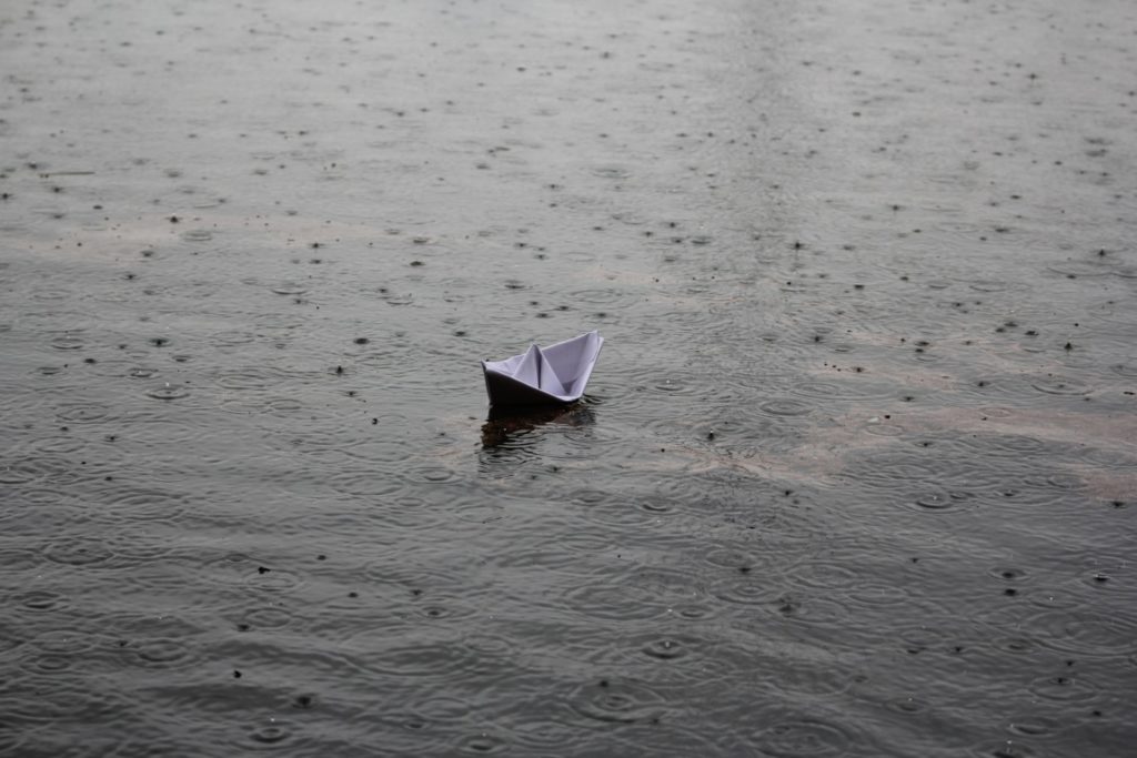 Paper boat out at sea in storm